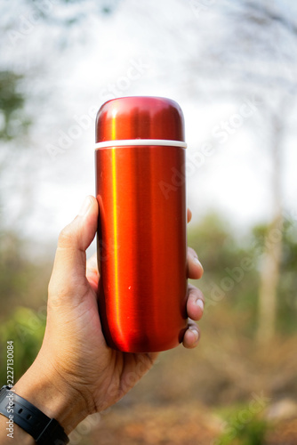 Close up of hand holding red tumbler
