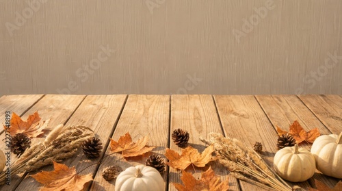 Fall harvest arrangement of dried wheat stalks and pumpkins on wood