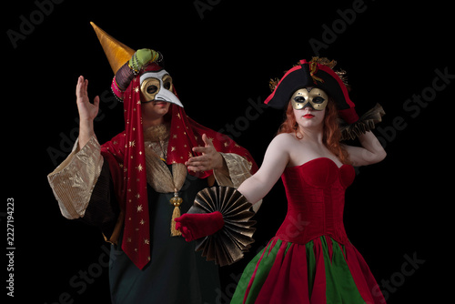 Fotografie Two masked performers in elaborate red and gold costumes dancing during a tradit