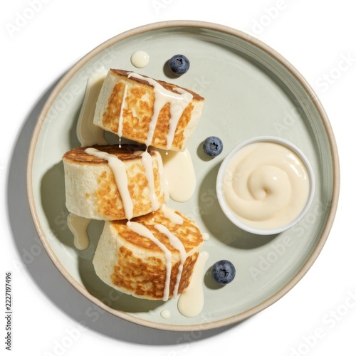 Ultra photorealistic top down view of three fluffy syrniki with condensed milk and blueberries on a green plate — commercial food photography for breakfast concept and russian cuisine editorial