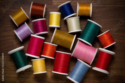 Multiple Colored Sewing Thread Rolls on Wood Table