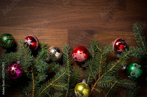 Merry Christmas, Christmas Balls with Fresh Evergreen Branches on Wood Table