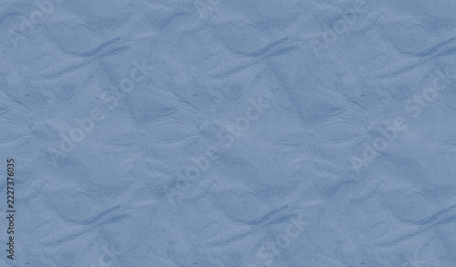 Light blue crumpled paper texture background with soft wrinkles and subtle handmade surface detail for design use