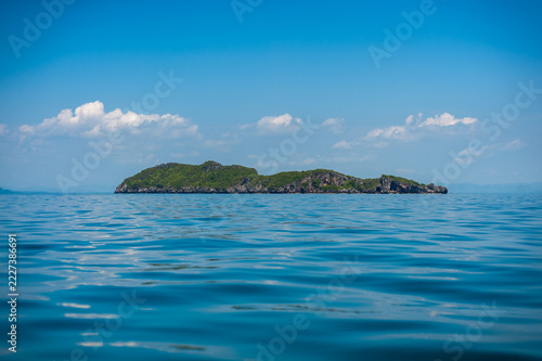 Sticker A limestone island in the sea, with the island, sky, and sea visible