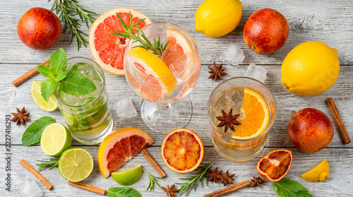 Fresh citrus slices garnished cocktails with herbs spices star anise cinnamon sticks flat lay