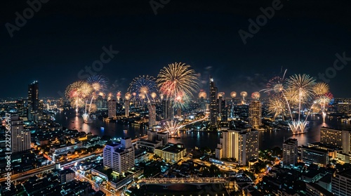 Spectacular Night Fireworks Display Over City Skyline and River