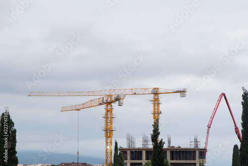 Construction crane tower background. Crane and building working progress. Worker. Construction concept. New buildings with a crane. Tower crane