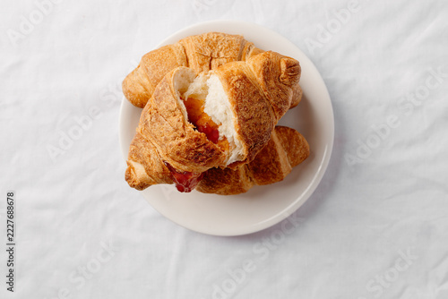 Fresh croissant on white plate