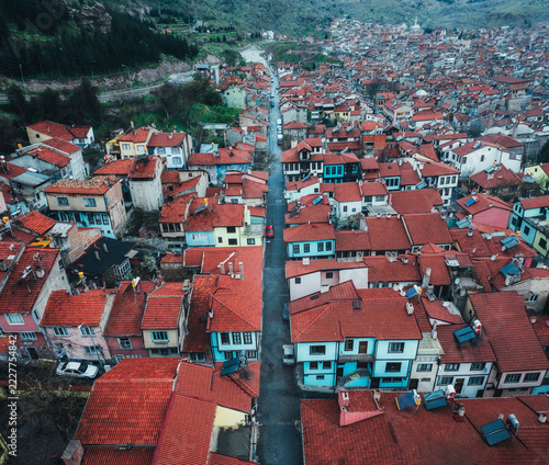 Fotografie Red tiled old town rooftops and a minaret seen from above