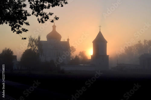Autumn landscape. A view of St. Nicholas Church in the fog at sunrise