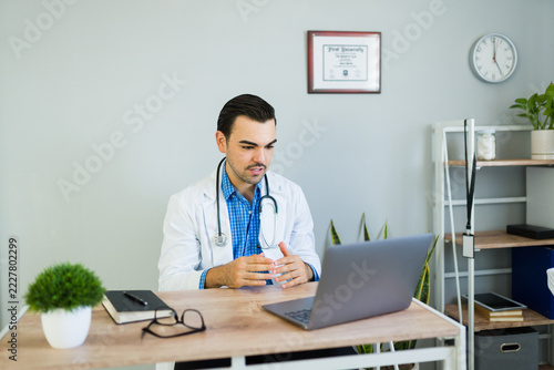 Hispanic doctor having an online consultation, discussing healthcare information during a telemedicine video call