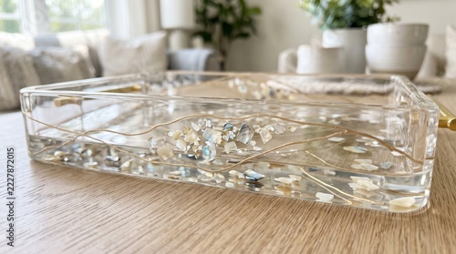 Clear epoxy resin serving tray with dried botanicals on wooden table