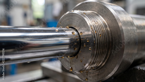 Chrome hydraulic piston cylinder and mechanical pivot joint close up with copy space