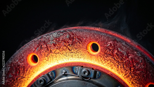 Performance ventilated brake disc rotor glowing hot orange on dyno test with copy space