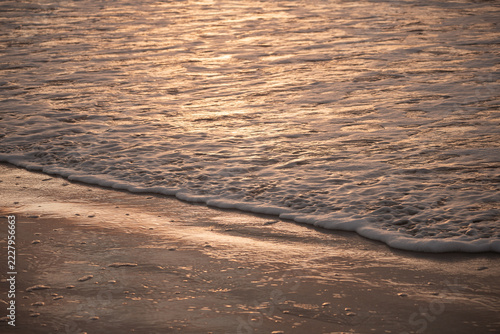 golden sunset reflection on the beach background