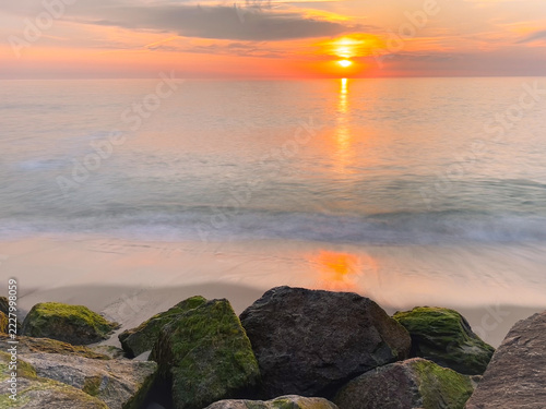 Golden Ocean Sunset Over Mossy Coastline Rocks