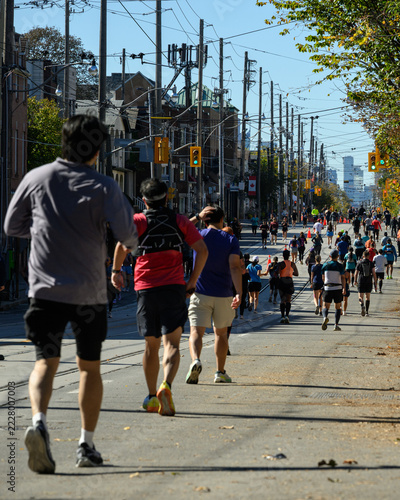 Photography Marathon runners on Queen Street East toward Toronto skyline