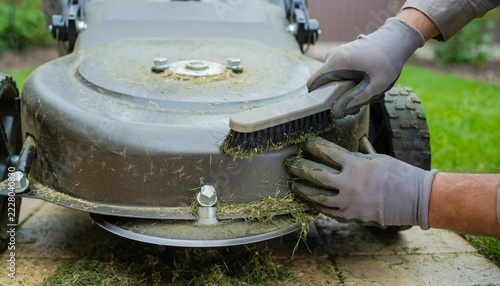 Worker Wearing Protective Gloves Cleaning and Maintaining Outdoor Industrial Equipment