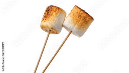 Two delicious roasted toasted marshmallows sweet confectionery dessert treats on wooden sticks, isolated on transparent background.