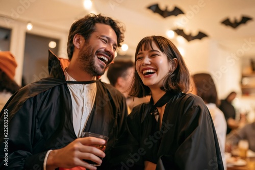 Happy friends enjoying Halloween party celebration in costumes