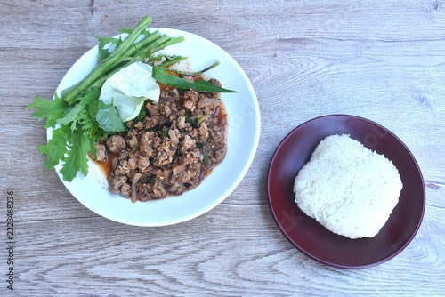 Thai spicy chop beef meat salad with fresh vegetable on plate eat couple sticky rice