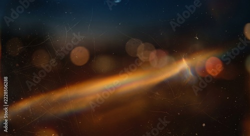 A captivating display of abstract light features a colorful spectrum and bokeh effect. The interplay of colors and blurred circles creates a mesmerizing visual experience.