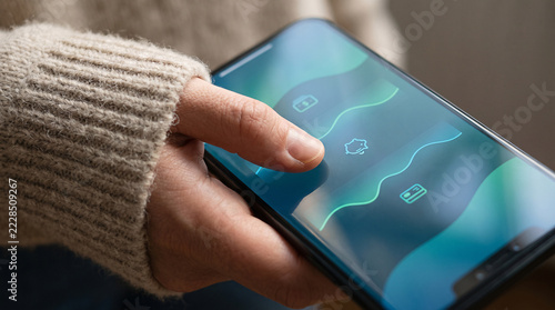 Close-up of hand holding smartphone and touching screen with online banking app UI. Concept of mobile payment, e-banking, digital finance management, and online shopping