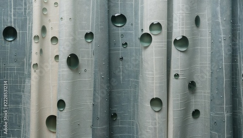 Water droplets on softly folded green textured fabric