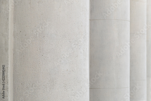 Classical stone columns closeup of facade of a classical neoclassical building. Smooth concrete textured surfaces