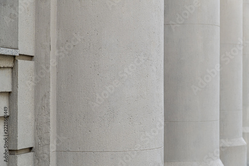 Classical stone columns closeup of facade of a classical neoclassical building. Smooth concrete textured surfaces