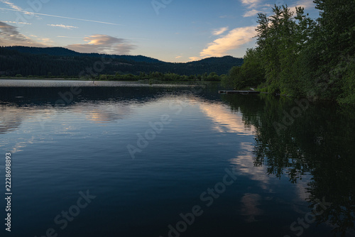 VIEW OF LAKE COEUR D'ALENE LAKE IN IDAHO FROM THE BACK SIDE OF THE LAKEVIEW LODGE IN HARRISON IDAHO WITH A NICE REFLECTION AND CELAR BLUE SKY WITH A FEW CLOUDS