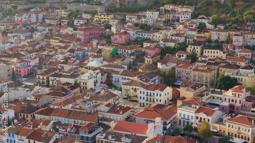 Aerial perspective revealing the dense urban landscape of Nafplio. Greece. Showcasing its colorful neoclassical buildings and traditional red-tiled roofs nestled together in the historic city center