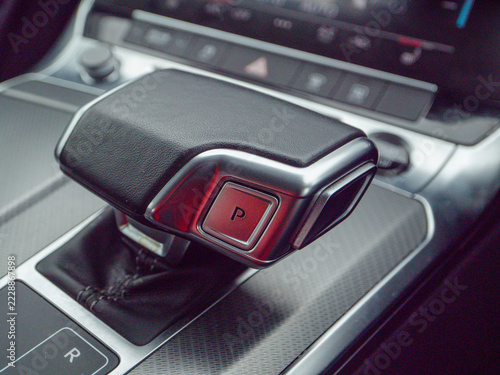Fotografie Close-up of modern car's gear shift lever with 'P' parking position illuminated red