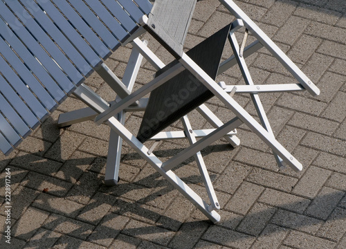 Tables and chairs on a terrace by the sea