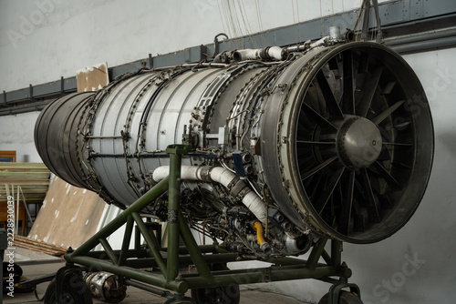 Jet Engine on Stand in Aircraft Maintenance Hangar. Turbojet aircraft engine.