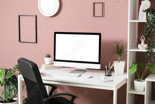 Remote work and home office setup, computer with blank screen on desk for fre...