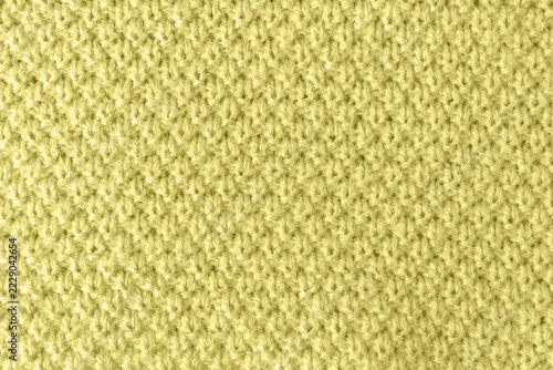 Textured knitted surface in trendy yellow-green autumn color.