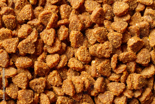 Dry dog and cat food kibble macro texture background. Detailed macro shot of dry pet food kibbles.
