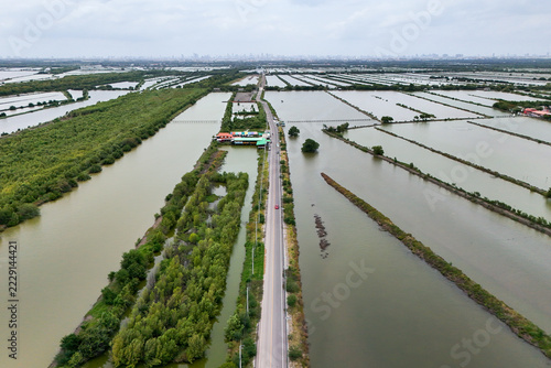 Aerial view of an asphalt road through Na Klea district in central Thailand.