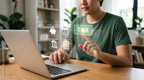 Person using laptop computer with virtual tax interface screen icons