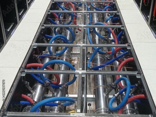 Obraz na plátně Liquid cooling system piping infrastructure under raised floor in high performance data center, blue and red coolant pipes for server racks