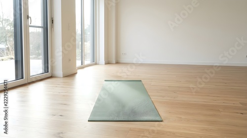 Minimalist yoga mat placed in a bright, spacious, and empty room