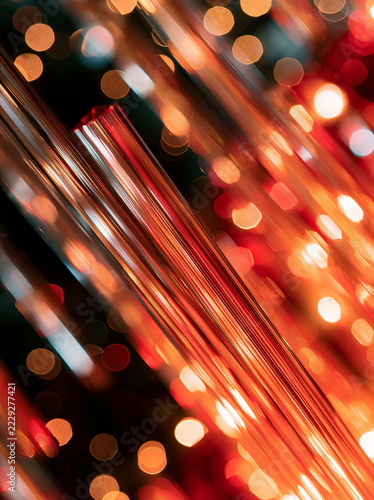 Macro shot of chandelier crystals reflecting red and amber light