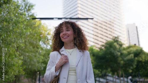 Young businesswoman walking through the city while talking on mobile phone