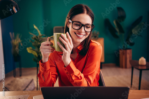 Obraz na plátně Business professional woman in glasses smiling while working from home with coff