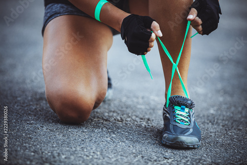 Woman Tying Running Shoes Before an Outdoor Workout