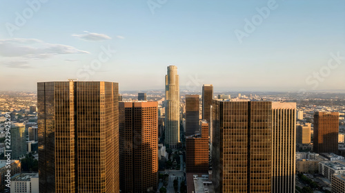 Modern pixel art city skyline with high rise buildings at sunset