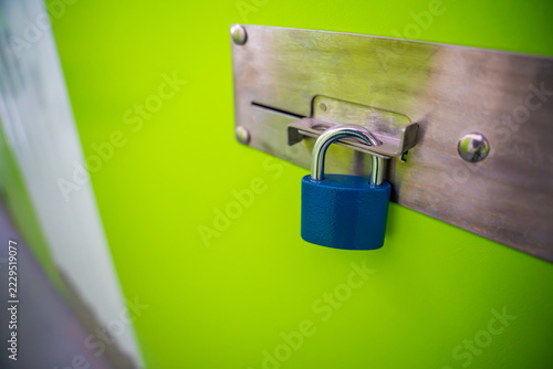 Fotografie Padlock secures a metal latch on a self storage unit door