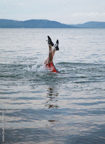 A young boy swimming in Batchewana Lake in Ontario, Canada.