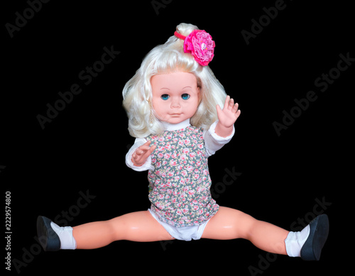 Miniature toy doll on a black background.